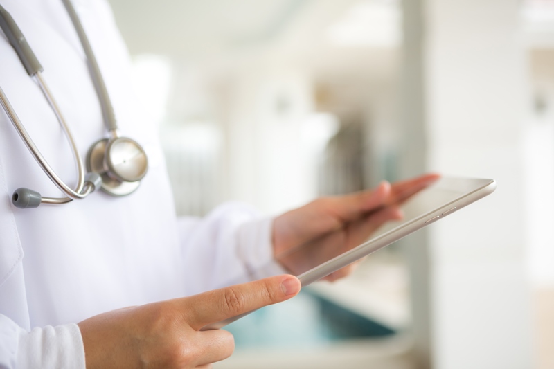 Doctor using tablet computer